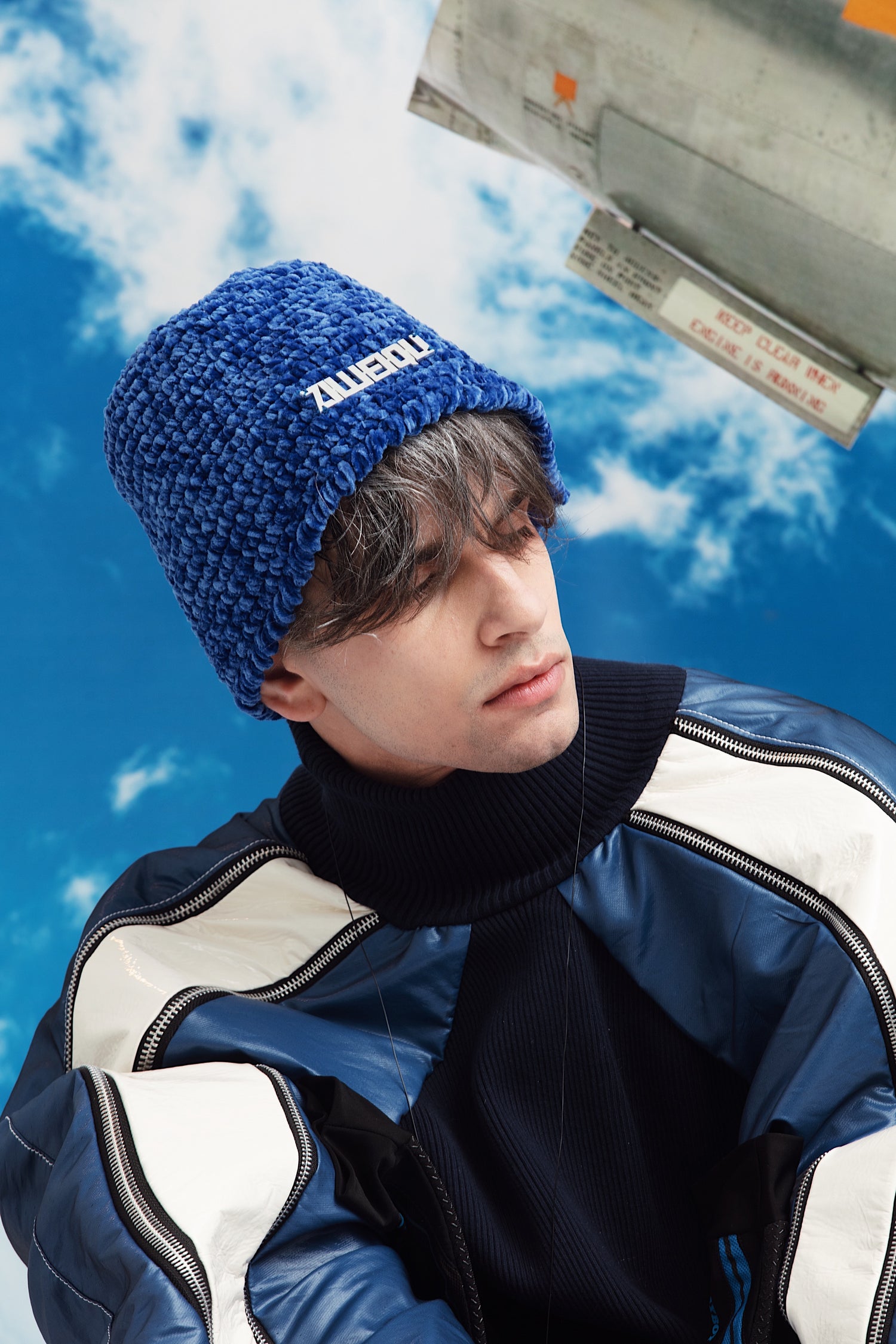 Profile shot of model wearing YYAtomic's Logo Beanie and looking to the side.