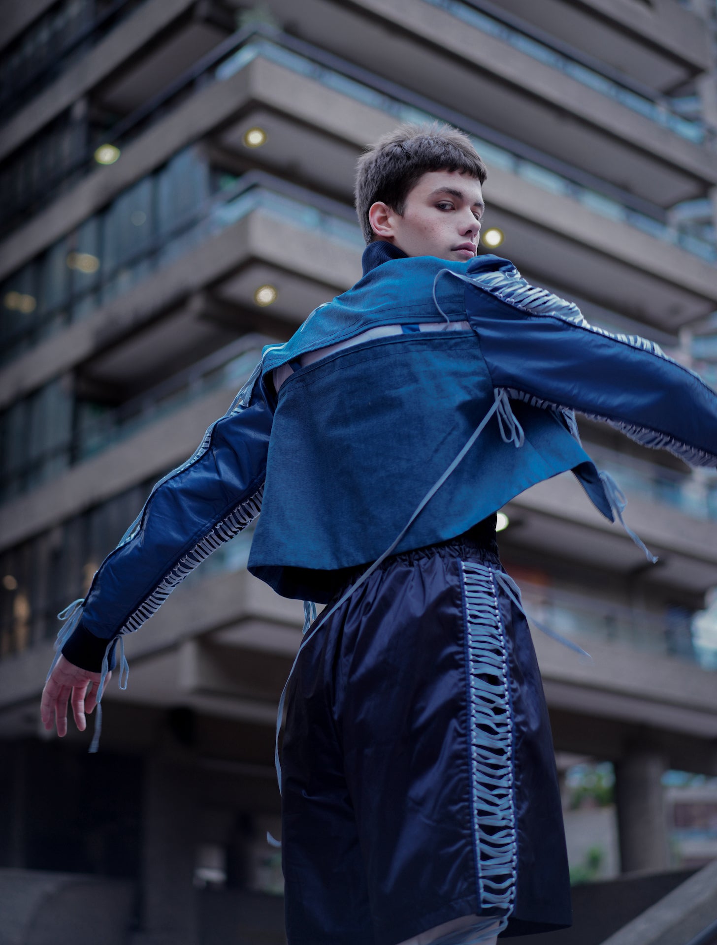 Side and back shot of model wearing YYAtomic Blue Denim Lacing Jacket